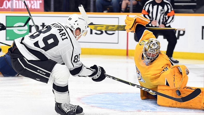 Oct 19, 2021; Nashville, Tennessee, USA; Los Angeles Kings center Rasmus Kupari (89) has a shot blocked by Nashville Predators goaltender Juuse Saros (74) during the second period at Bridgestone Arena. Mandatory Credit: Christopher Hanewinckel-USA TODAY Sports