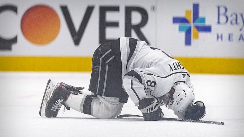 Oct 22, 2021; Dallas, Texas, USA; Los Angeles Kings defenseman Drew Doughty (8) lies on the ice after getting injured on a hit by Dallas Stars defenseman Jani Hakanpaa (not pictured) during the second period at the American Airlines Center. Mandatory Credit: Jerome Miron-USA TODAY Sports