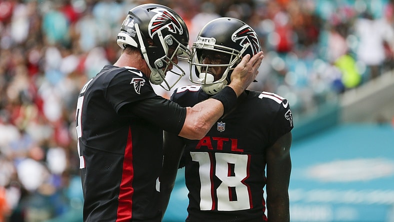 Oct 24, 2021; Miami Gardens, Florida, USA; Atlanta Falcons wide receiver Calvin Ridley (18) gets a tap on the helmet from quarterback Matt Ryan (2) after scoring a touchdown against the Miami Dolphins during the second quarter of the game at Hard Rock Stadium. Mandatory Credit: Sam Navarro-USA TODAY Sports