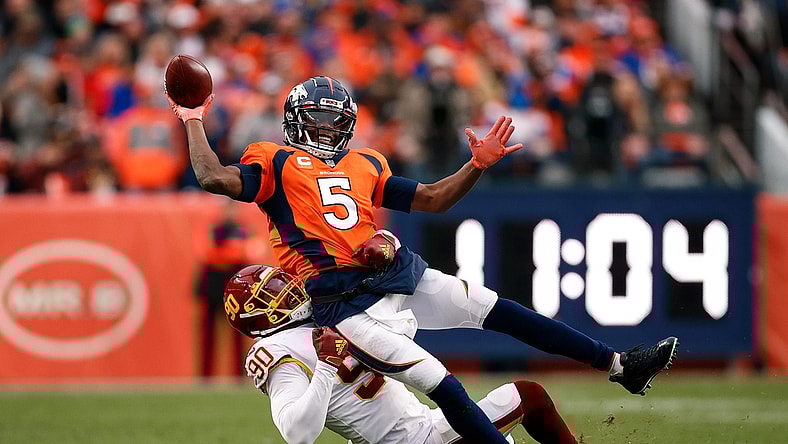 Oct 31, 2021; Denver, Colorado, USA; Denver Broncos quarterback Teddy Bridgewater (5) attempts to pass the ball as he is tackled by Washington Football Team defensive end Montez Sweat (90) in the fourth quarter at Empower Field at Mile High. Mandatory Credit: Isaiah J. Downing-USA TODAY Sports