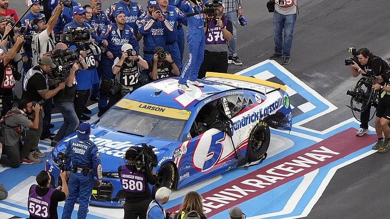 Nov 7, 2021; Avondale, Arizona, USA; NASCAR Cup Series driver Kyle Larson (5) celebrates winning the NASCAR Cup Series Championship at Phoenix Raceway. Mandatory Credit: Mike Dinovo-USA TODAY Sports