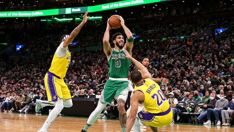 Nov 19, 2021; Boston, Massachusetts, USA; Boston Celtics forward Jayson Tatum (0) drives to the basket defended by Los Angeles Lakers guard Avery Bradley (20) and Los Angeles Lakers forward Anthony Davis (3) during the first half at TD Garden. Mandatory Credit: Paul Rutherford-USA TODAY Sports