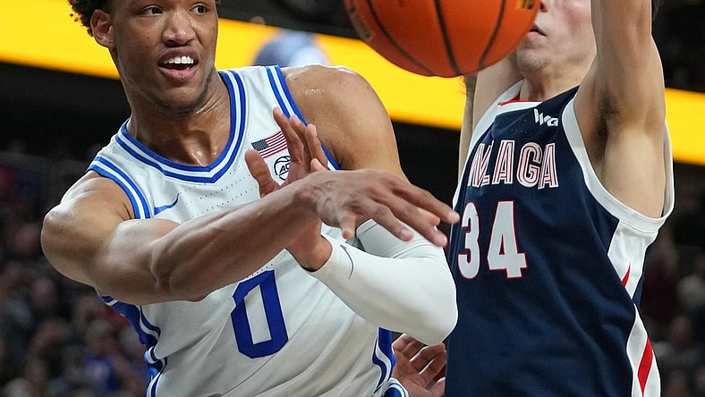 Nov 26, 2021; Las Vegas, Nevada, USA; Duke Blue Devils forward Wendell Moore Jr. (0) makes a pass under the basket as Gonzaga Bulldogs center Chet Holmgren (34) defends the basket during the second half at T-Mobile Arena. Mandatory Credit: Stephen R. Sylvanie-USA TODAY Sports