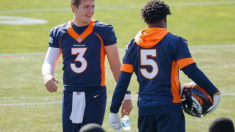 Jul 28, 2021; Englewood, CO, United States; Denver Broncos quarterback Drew Lock (left) talks with quarterback Teddy Bridgewater (right) during training camp at UCHealth Training Complex.