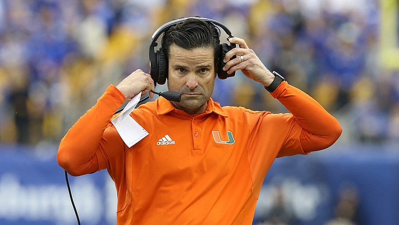 Oct 30, 2021; Pittsburgh, Pennsylvania, USA;  Miami Hurricanes head coach Manny Diaz puts his headset on against the Pittsburgh Panthers during the fourth quarter at Heinz Field. Mandatory Credit: Charles LeClaire-USA TODAY Sports