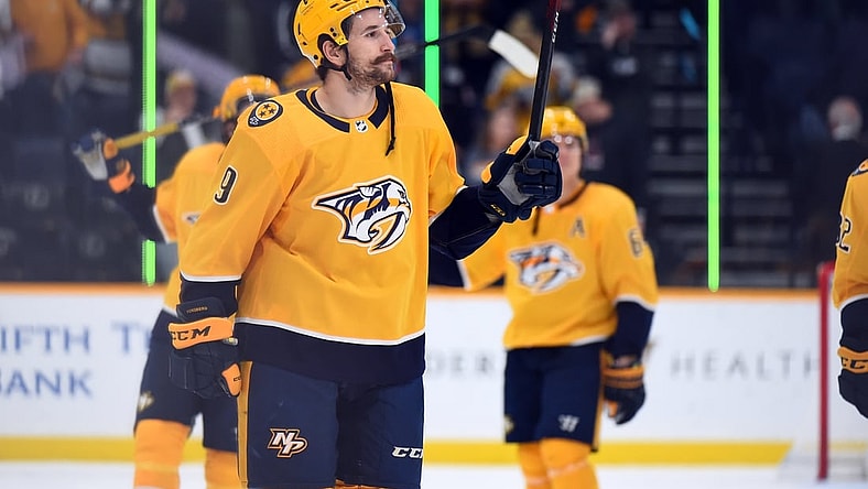 Nov 30, 2021; Nashville, Tennessee, USA; Nashville Predators left wing Filip Forsberg (9) celebrates after a four goal game in the 6-0 win over the Columbus Blue Jackets at Bridgestone Arena. Mandatory Credit: Christopher Hanewinckel-USA TODAY Sports