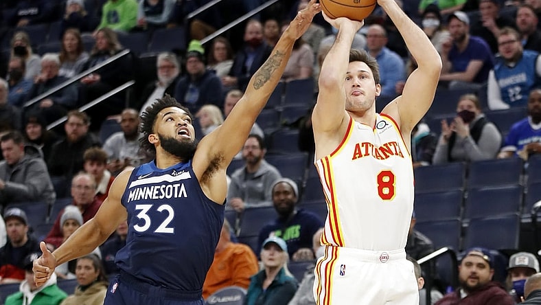 Dec 6, 2021; Minneapolis, Minnesota, USA; Atlanta Hawks forward Danilo Gallinari (8) shoots as Minnesota Timberwolves center Karl-Anthony Towns (32) tries tro defend him in the first quarter at Target Center. Mandatory Credit: Bruce Kluckhohn-USA TODAY Sports