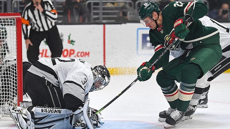 Dec 11, 2021; Los Angeles, California, USA; Los Angeles Kings goaltender Jonathan Quick (32) blocks the puck as Minnesota Wild center Nick Bjugstad (27) tried to poke it under his glove in the first period of the game at Staples Center. Mandatory Credit: Jayne Kamin-Oncea-USA TODAY Sports