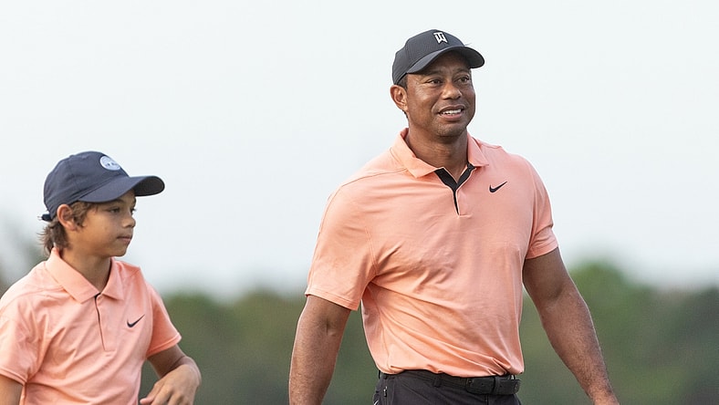Dec 18, 2021; Orlando, Florida, USA; Tiger Woods walks off 18th green during the first round of the PNC Championship golf tournament at Grande Lakes Orlando Course. Mandatory Credit: Jeremy Reper-USA TODAY Sports