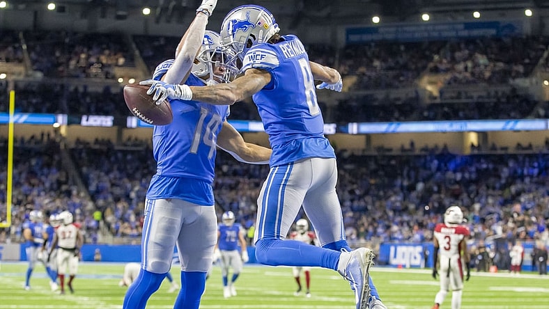 Dec 19, 2021; Detroit, Michigan, USA; Detroit Lions wide receiver Josh Reynolds (8) catches a pass for a TD and celebrates with receiver Amon-Ra St. Brown (14) during the first half against the Arizona Cardinals at Ford Field. Mandatory Credit: David Reginek-USA TODAY Sports