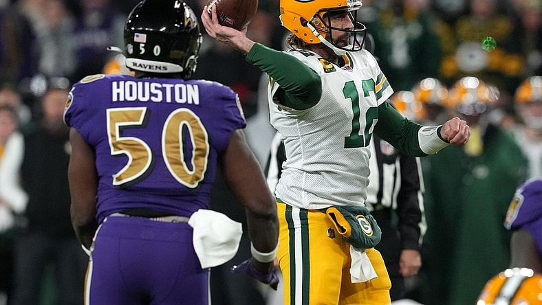 Dec 19, 2021; Baltimore, Maryland, USA; Green Bay Packers quarterback Aaron Rodgers (12) throws a pass while pressured by Baltimore Ravens linebacker Justin Houston (50) in the second quarter at M&T Bank Stadium. Mandatory Credit: Mitch Stringer-USA TODAY Sports
