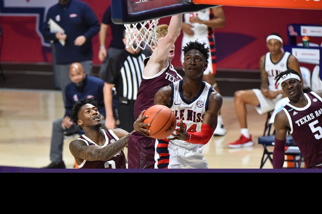 Jan 23, 2021; Oxford, Mississippi, USA; Mississippi Rebels guard Jarkel Joiner (24) lays the ball up against Texas A&M Aggies guard Quenton Jackson (3) during the second half at The Pavilion at Ole Miss. Mandatory Credit: Justin Ford-USA TODAY Sports