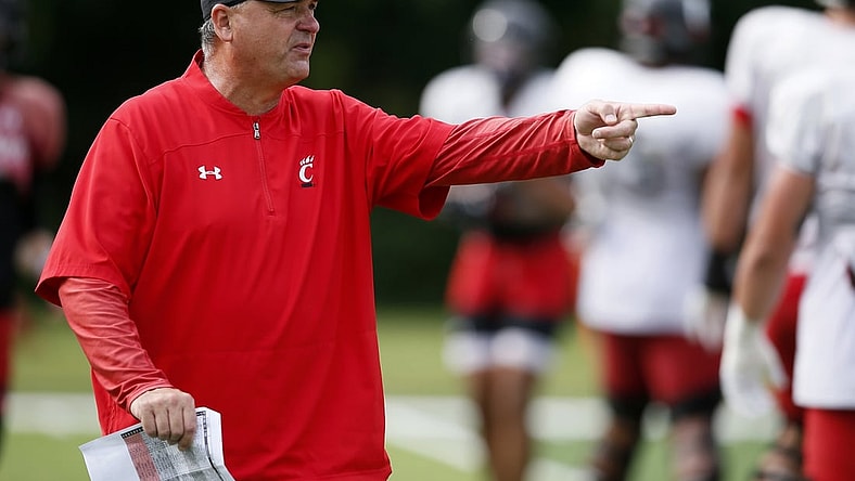 Aug 9, 2021; West Harrison, Indiana, USA; Cincinnati Bearcats offensive coordinator Mike Denbrock directs a drill during practice at the Higher Ground training facility. Mandatory Credit: Sam Greene/The Cincinnati Enquirer via USA TODAY NETWORK