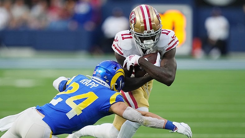 Jan 9, 2022; Inglewood, California, USA; San Francisco 49ers wide receiver Brandon Aiyuk (11) is tackled by Los Angeles Rams free safety Taylor Rapp (24) in the second half at SoFi Stadium. Mandatory Credit: Kirby Lee-USA TODAY Sports