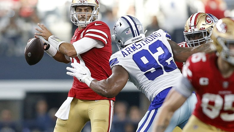 Jan 16, 2022; Arlington, Texas, USA; San Francisco 49ers quarterback Jimmy Garoppolo (10) throws the ball against Dallas Cowboys defensive end Dorance Armstrong (92) in the second quarter in a NFC Wild Card playoff football game at AT&T Stadium. Mandatory Credit: Tim Heitman-USA TODAY Sports