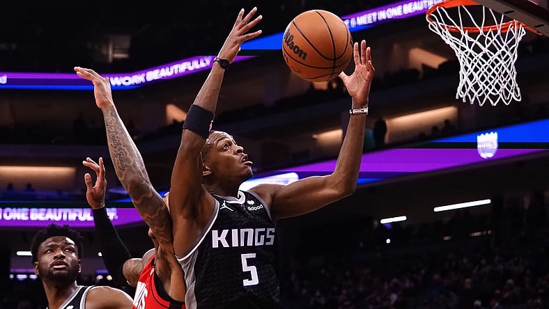 Jan 16, 2022; Sacramento, California, USA; Sacramento Kings guard De'Aaron Fox (5) controls a rebound against the Houston Rockets during the second quarter at Golden 1 Center. Mandatory Credit: Kelley L Cox-USA TODAY Sports