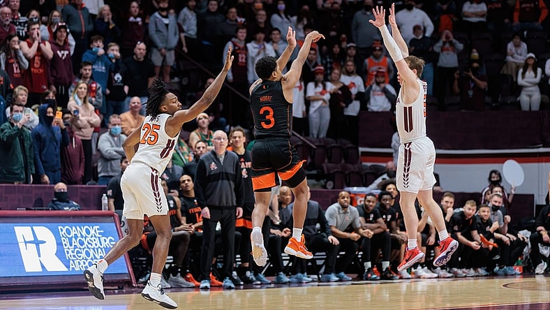 Jan 26, 2022; Blacksburg, Virginia, USA; Miami Hurricanes guard Charlie Moore (3) shoots a buzzer beater three-pointer over Virginia Tech Hokies guard Storm Murphy (5) during the second half at Cassell Coliseum. Mandatory Credit: Ryan Hunt-USA TODAY Sports