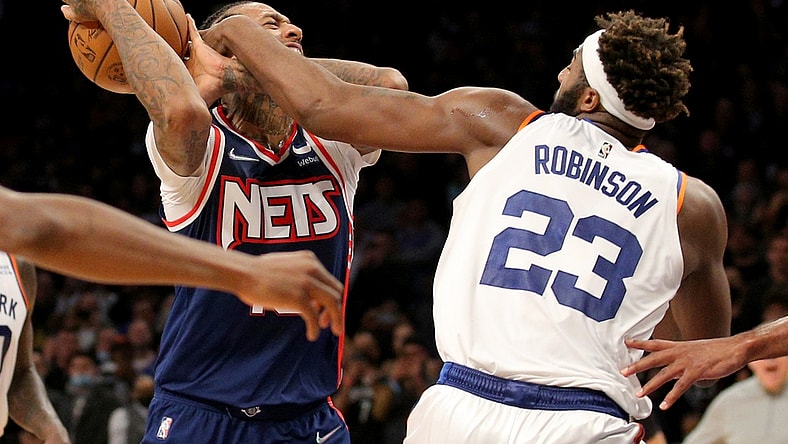 Nov 30, 2021; Brooklyn, New York, USA; Brooklyn Nets forward James Johnson (16) is fouled as he drives to the basket by New York Knicks center Mitchell Robinson (23) during the fourth quarter at Barclays Center. Mandatory Credit: Brad Penner-USA TODAY Sports
