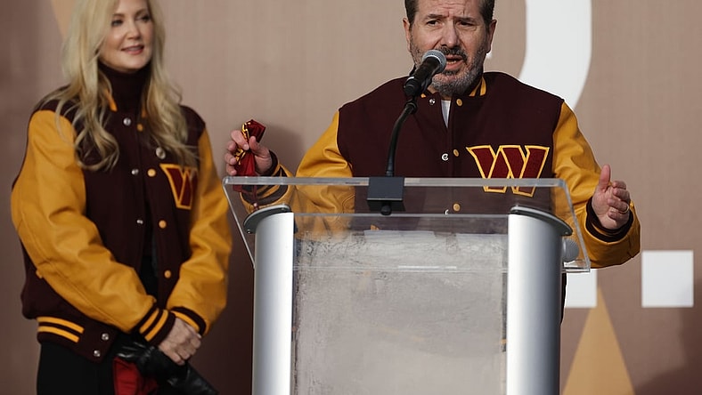 Feb 2, 2022; Landover, MD, USA; Washington Commanders co-owner Dan Snyder speaks as co-owner Tanya Snyder (L) listens during a press conference revealing the Commanders as the new name for the formerly named Washington Football Team at FedEx Field. Mandatory Credit: Geoff Burke-USA TODAY Sports