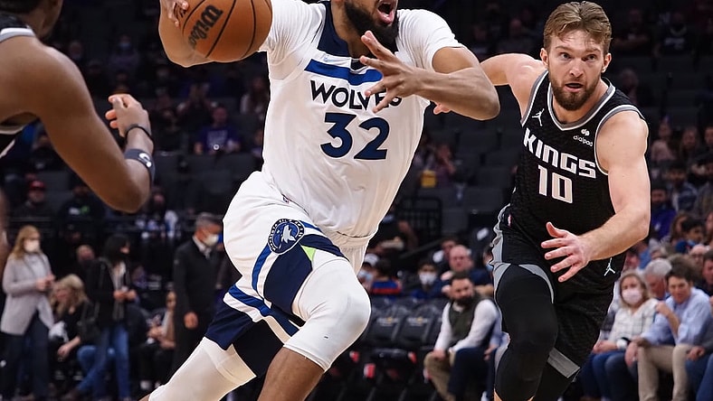Feb 9, 2022; Sacramento, California, USA; Minnesota Timberwolves center Karl-Anthony Towns (32) drives in against Sacramento Kings center Domantas Sabonis (10) during the first quarter at Golden 1 Center. Mandatory Credit: Kelley L Cox-USA TODAY Sports