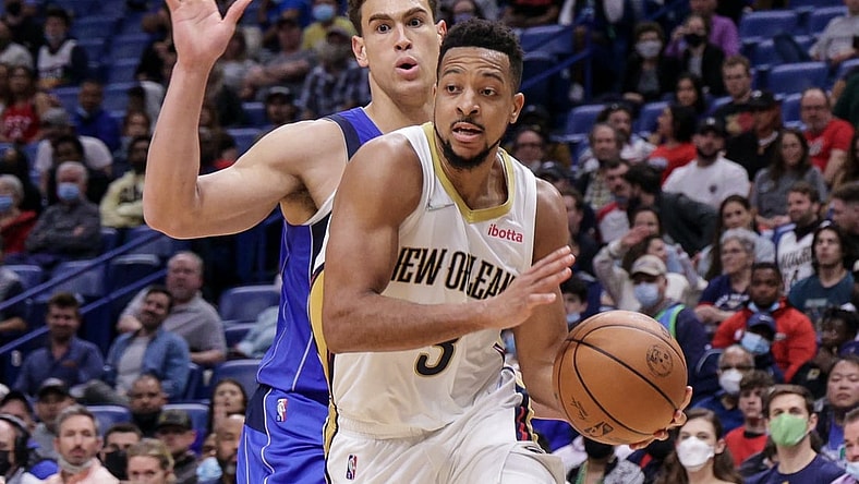 Feb 17, 2022; New Orleans, Louisiana, USA; New Orleans Pelicans guard CJ McCollum (3) dribbles against Dallas Mavericks center Dwight Powell (7) during the second half at the Smoothie King Center. Mandatory Credit: Stephen Lew-USA TODAY Sports