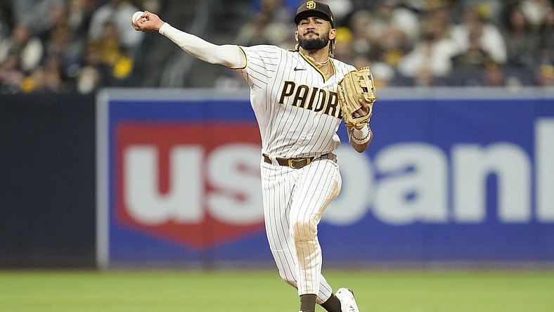 Sep 24, 2021; San Diego, California, USA; San Diego Padres shortstop Fernando Tatis Jr. (23) throws to first base against the Atlanta Braves during the fifth inning at Petco Park. Mandatory Credit: Ray Acevedo-USA TODAY Sports