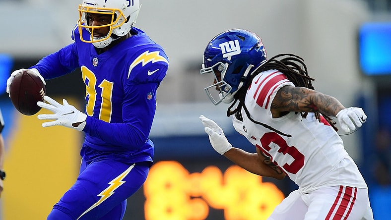 Dec 12, 2021; Inglewood, California, USA; Los Angeles Chargers wide receiver Mike Williams (81) runs the ball ahead of New York Giants safety Logan Ryan (23) during the first half at SoFi Stadium. Mandatory Credit: Gary A. Vasquez-USA TODAY Sports