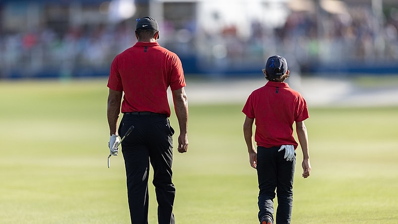 Dec 19, 2021; Orlando, Florida, USA; Tiger Woods and his son Charlie Woods walking down the 18th fairway during the final round of the PNC Championship golf tournament at Grande Lakes Orlando Course. Mandatory Credit: Jeremy Reper-USA TODAY Sports