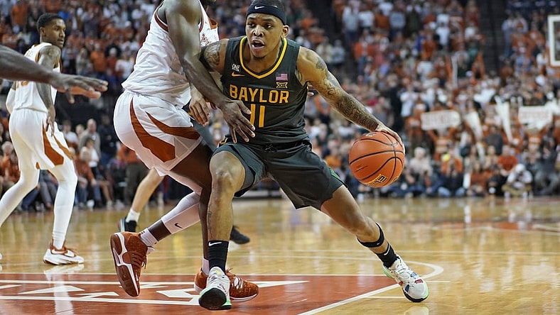 Feb 28, 2022; Austin, Texas, USA; Baylor Bears guard James Akinjo (11) drives to the basket while defended by Texas Longhorns guard Marcus Carr (2) during the second half at Frank C. Erwin Jr. Center. Mandatory Credit: Scott Wachter-USA TODAY Sports