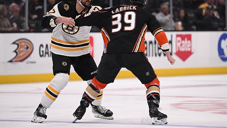 Mar 1, 2022; Anaheim, California, USA; Boston Bruins left wing Nick Foligno (17) fights Anaheim Ducks center Sam Carrick (39) during the first period at Honda Center. Mandatory Credit: Orlando Ramirez-USA TODAY Sports