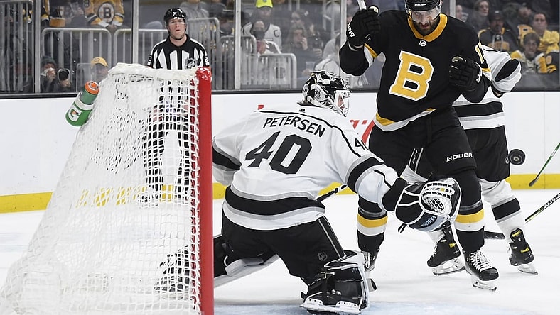 Mar 7, 2022; Boston, Massachusetts, USA;  Boston Bruins left wing Nick Foligno (17) eyes the puck as it goes past Los Angeles Kings goaltender Cal Petersen (40) during the first period at TD Garden. Mandatory Credit: Bob DeChiara-USA TODAY Sports