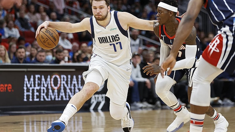 Mar 11, 2022; Houston, Texas, USA; Dallas Mavericks guard Luka Doncic (77) drives with the ball as Houston Rockets guard Dennis Schroder (17) defends during the third quarter at Toyota Center. Mandatory Credit: Troy Taormina-USA TODAY Sports