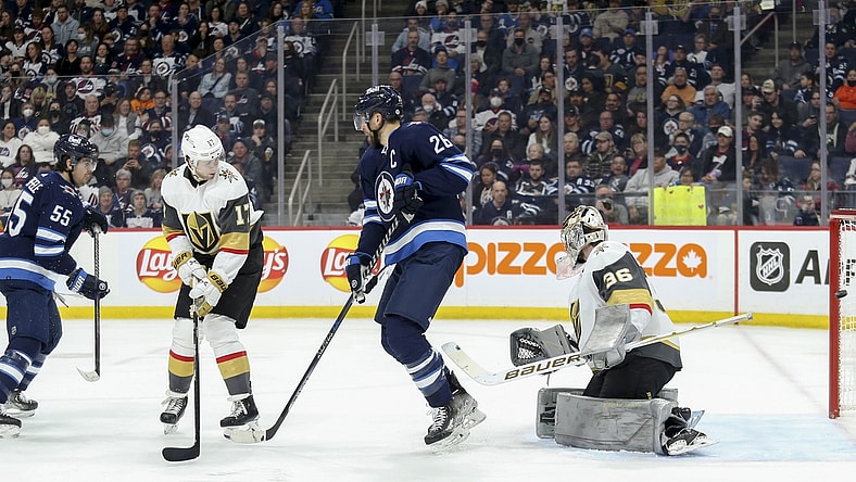 Mar 22, 2022; Winnipeg, Manitoba, CAN;  Winnipeg Jets forward Mark Scheifele (55) scores against Vegas Golden Knights goalie Logan Thompson (36) during the second period at Canada Life Centre. Mandatory Credit: Terrence Lee-USA TODAY Sports