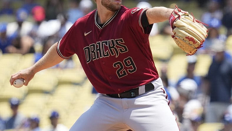 Jul 11, 2021; Los Angeles, California, USA; Arizona Diamondbacks starting pitcher Merrill Kelly (29) delivers a pitch during the first inning against the Los Angeles Dodgers at Dodger Stadium. Mandatory Credit: Robert Hanashiro-USA TODAY Sports
