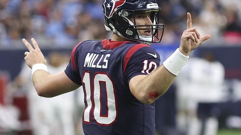 Jan 9, 2022; Houston, Texas, USA; Houston Texans quarterback Davis Mills (10) signals for the team to go for a two point conversion against the Tennessee Titans in the fourth quarter at NRG Stadium. Mandatory Credit: Thomas Shea-USA TODAY Sports
