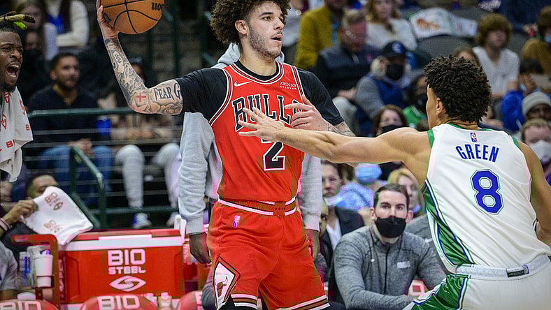 Jan 9, 2022; Dallas, Texas, USA; Chicago Bulls guard Lonzo Ball (2) looks to pass the ball by Dallas Mavericks guard Josh Green (8) during the second quarter at the American Airlines Center. Mandatory Credit: Jerome Miron-USA TODAY Sports