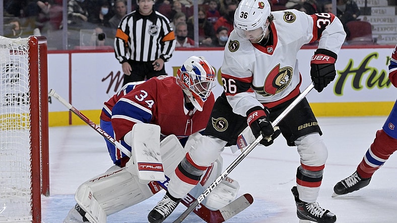 Mar 19, 2022; Montreal, Quebec, CAN; Montreal Canadiens goalie Jake Allen (34) stops Ottawa Senators forward Colin White (36) during the first period at the Bell Centre. Mandatory Credit: Eric Bolte-USA TODAY Sports