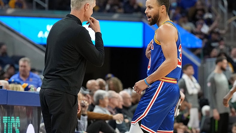 Mar 12, 2022; San Francisco, California, USA; Golden State Warriors guard Stephen Curry (30) talks to head coach Steve Kerr during the third quarter against the Milwaukee Bucks at Chase Center. Mandatory Credit: Darren Yamashita-USA TODAY Sports