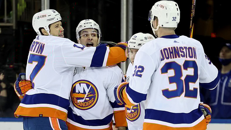 Apr 1, 2022; New York, New York, USA; New York Islanders left wing Matt Martin (17) celebrates his goal against the New York Rangers with center Mathew Barzal (13) and defenseman Sebastian Aho (25) and left wing Ross Johnston (32) during the second period at Madison Square Garden. Mandatory Credit: Brad Penner-USA TODAY Sports