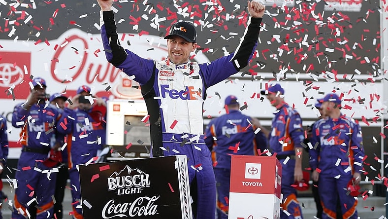 Apr 3, 2022; Richmond, Virginia, USA; NASCAR Cup Series driver Denny Hamlin (11) celebrates in Victory Lane after winning the Toyota Owners 400 at Richmond International Raceway. Mandatory Credit: Amber Searls-USA TODAY Sports