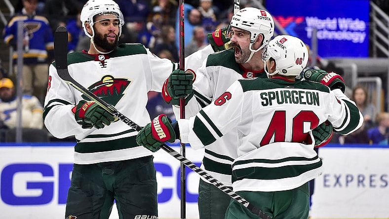 Apr 8, 2022; St. Louis, Missouri, USA;  Minnesota Wild defenseman Jacob Middleton (5) celebrates with defenseman Jared Spurgeon (46) and left wing Jordan Greenway (18) after scoring against the St. Louis Blues during the third period at Enterprise Center. Mandatory Credit: Jeff Curry-USA TODAY Sports