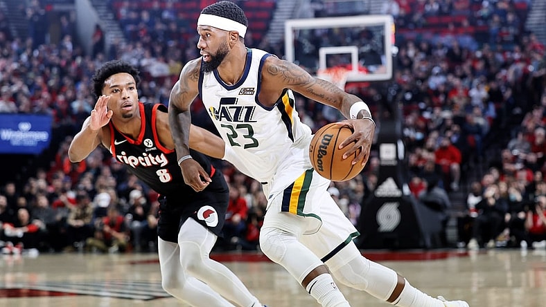 Apr 10, 2022; Portland, Oregon, USA; Utah Jazz power forward Royce O'Neale (23) dribbles the ball while defended by  Portland Trail Blazers point guard Brandon Williams (8) during the first half at Moda Center. Mandatory Credit: Soobum Im-USA TODAY Sports