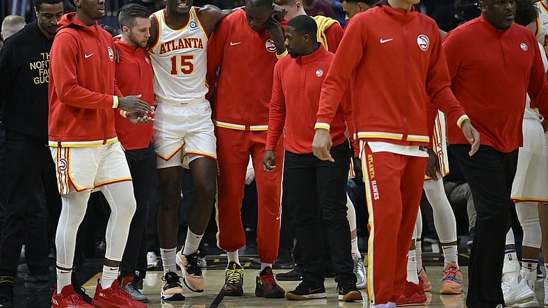Apr 15, 2022; Cleveland, Ohio, USA; Atlanta Hawks center Clint Capela (15) is helped off the court in the second quarter against the Cleveland Cavaliers at Rocket Mortgage FieldHouse. Mandatory Credit: David Richard-USA TODAY Sports