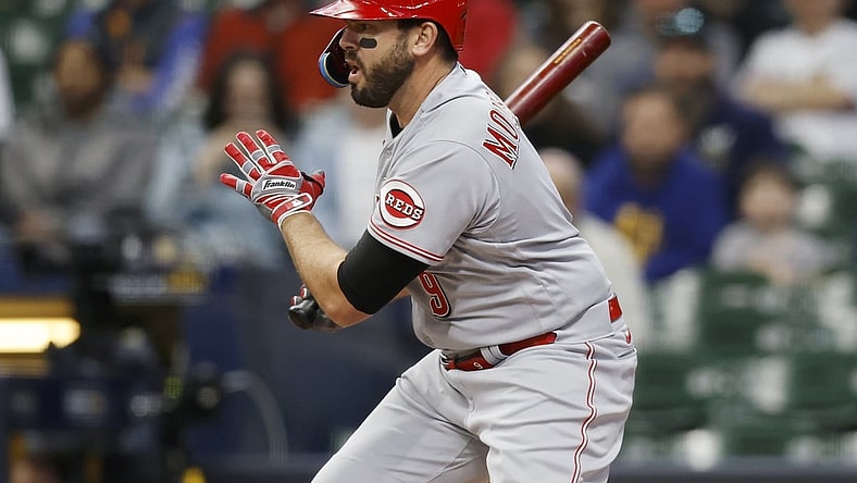 May 4, 2022; Milwaukee, Wisconsin, USA;  Cincinnati Reds designated hitter Mike Moustakas (9) hits an RBI single during the first inning against the Milwaukee Brewers at American Family Field. Mandatory Credit: Jeff Hanisch-USA TODAY Sports