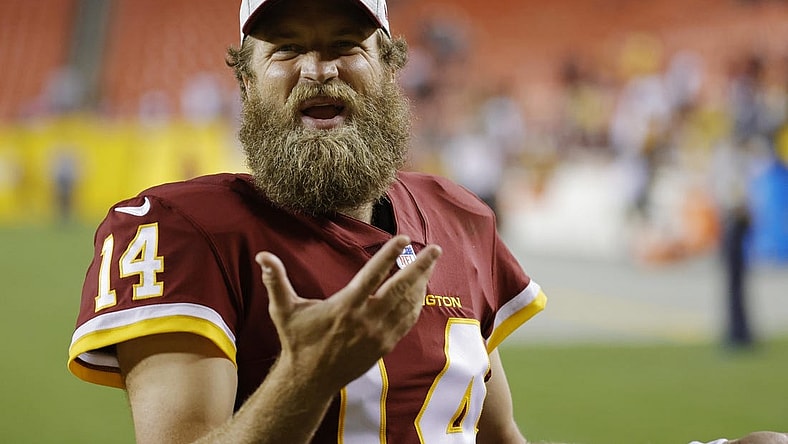 Aug 20, 2021; Landover, Maryland, USA; Washington Football Team quarterback Ryan Fitzpatrick (14) talks to fans while leaving the field after the Washington Football Team's game against the Cincinnati Bengals at FedExField. Mandatory Credit: Geoff Burke-USA TODAY Sports