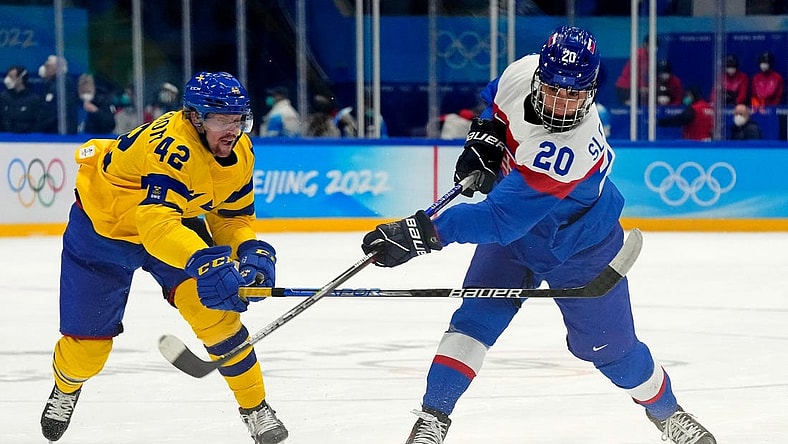Feb 19, 2022; Beijing, China; Team Slovakia forward Juraj Slafkovsky (20) shoots the puck against Team Sweden forward Joakim Nordstrom (42) during the first period in the bronze medal men s ice hockey game during the Beijing 2022 Olympic Winter Games at National Indoor Stadium. Mandatory Credit: George Walker IV-USA TODAY Sports