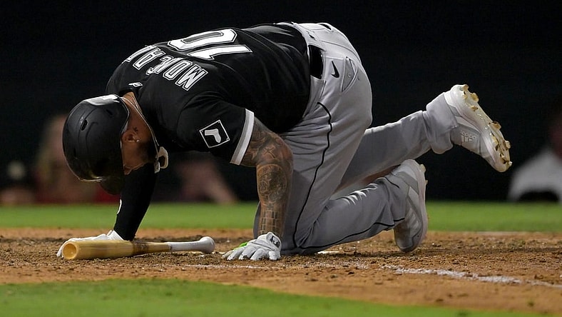 Jun 29, 2022; Anaheim, California, USA;  Chicago White Sox third baseman Yoan Moncada (10) hits the ground after fouling a ball off his foot in the eighth inning against the Los Angeles Angels at Angel Stadium. Mandatory Credit: Jayne Kamin-Oncea-USA TODAY Sports