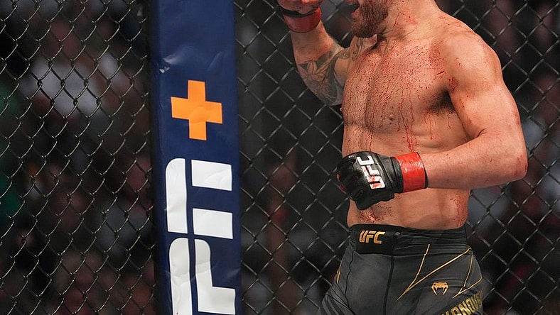 Jul 2, 2022; Las Vegas, Nevada, USA; (Editor s Note: Graphic Content) Alexander Volkanovski (red gloves) reacts after defeating Max Holloway (blue gloves) during UFC 276 at T-Mobile Arena. Mandatory Credit: Stephen R. Sylvanie-USA TODAY Sports