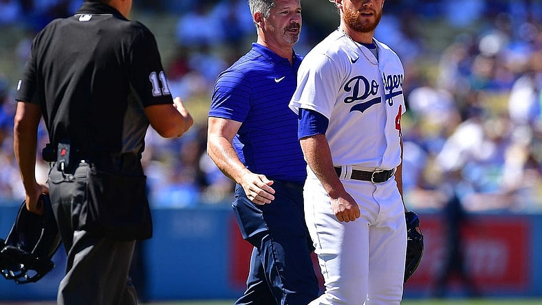 Jul 3, 2022; Los Angeles, California, USA; Los Angeles Dodgers relief pitcher Craig Kimbrel (46) with trainer Nate Lucero after taking a comeback hit by San Diego Padres second baseman Jake Cronenworth (9) during the ninth inning at Dodger Stadium. Mandatory Credit: Gary A. Vasquez-USA TODAY Sports