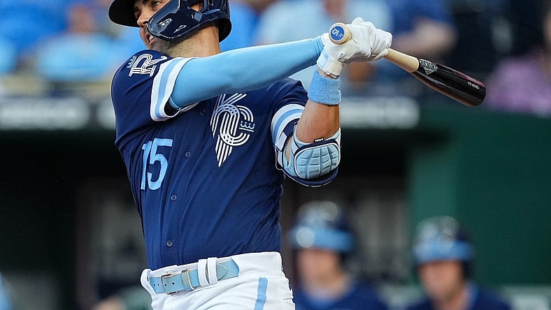 Jul 8, 2022; Kansas City, Missouri, USA; Kansas City Royals second baseman Whit Merrifield (15) hits a single against the Cleveland Guardians during the third inning at Kauffman Stadium. Mandatory Credit: Jay Biggerstaff-USA TODAY Sports